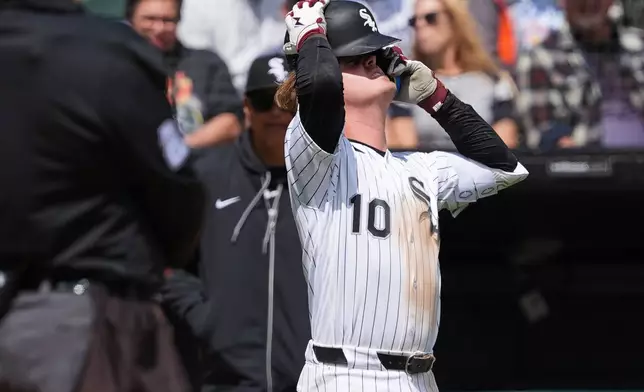 Chicago White Sox's Chase Meidroth puts on his helmet after an injury during the third inning of a baseball game against the Washington Nationals at Rate Field in Chicago, Sunday, April 26, 2026. (AP Photo/Nam Y. Huh)