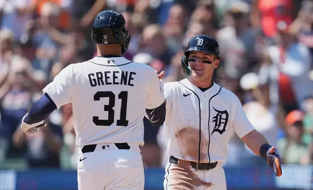 Detroit Tigers' Riley Greene (31) celebrates his two-run home run with Kevin McGonigle, right, against the Milwaukee Brewers during the first inning of a baseball game Thursday, April 23, 2026, in Detroit. (AP Photo/Paul Sancya)