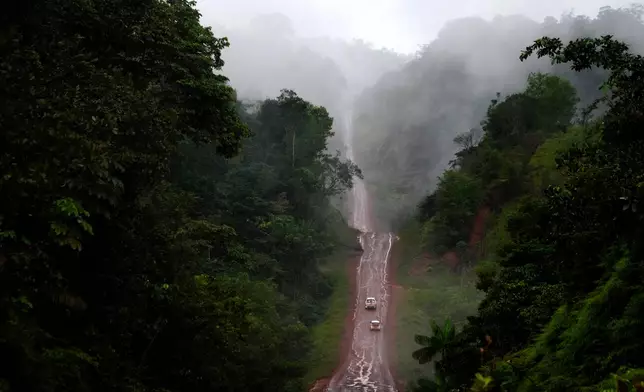 Vehicles move on an unpaved part of the BR-156 highway that connects the state capital Macapa with the city of Oiapoque, Amapa state, Brazil, Friday, March 13, 2026. (AP Photo/Eraldo Peres)