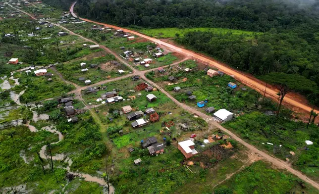 Trees line a cleared area known as Nova Conquista or New Conquest where families are building houses near the center of Oiapoque, Amapa state, Brazil, Wednesday, March 11, 2026. (AP Photo/Eraldo Peres)
