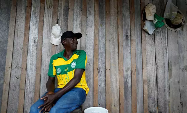 Reginaldo Nunes Fonseca sits on a balcony of the house he occupies in an area known as Nova Conquista or "new conquest" in Oiapoque, Amapa state, Brazil, Wednesday, March 11, 2026. (AP Photo/Eraldo Peres)