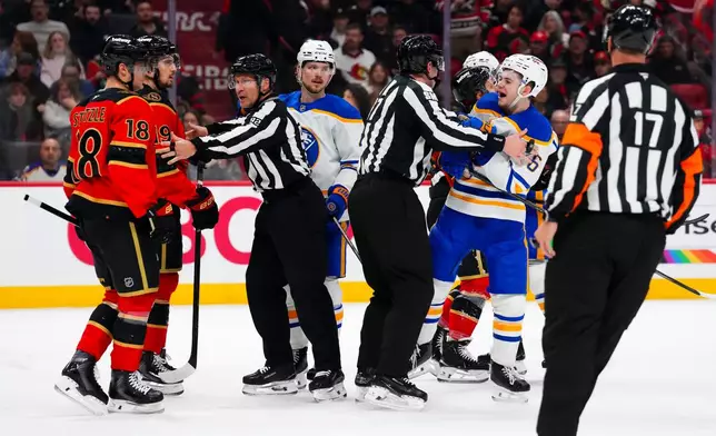 Buffalo Sabres' Zach Benson (6) yells at Ottawa Senators' Tim Stutzle (18) at the end of the first period of NHL hockey game action in Ottawa, Ontario, Thursday, April 2, 2026. (Sean Kilpatrick/The Canadian Press via AP)