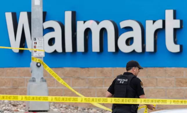 Omaha police work outside a Walmart store at South 72nd and Pine Streets in Omaha, Neb., on Tuesday, April 14, 2026, after police fatally shot a woman who was accused of cutting a young child's face with a knife. (Nikos Frazier/Omaha World-Herald via AP)