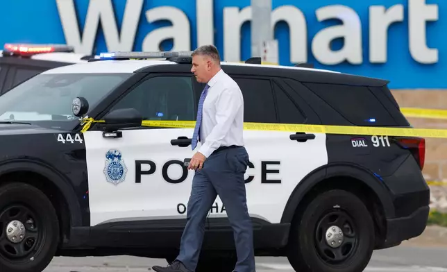Omaha Police Chief Todd Schmaderer arrives at a Walmart store at South 72nd and Pine Streets in Omaha, Neb., on Tuesday, April 14, 2026, after police fatally shot a woman who was accused of cutting a young child's face with a knife. (Nikos Frazier/Omaha World-Herald via AP)