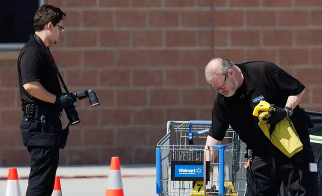 Omaha police work outside a Walmart store at South 72nd and Pine Streets in Omaha, Neb., on Tuesday, April 14, 2026, after police fatally shot a woman who was accused of cutting a young child's face with a knife. (Nikos Frazier/Omaha World-Herald via AP)