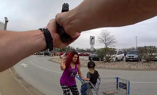 This police body cam still image provided by the Omaha Police Department shows an Omaha police officer responding to a woman they say kidnapped a young boy and slashed him across the face before killing her in Omaha, Neb. on Tuesday April 14, 2026. (Omaha Police Department via AP)