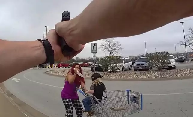 This police body cam still image provided by the Omaha Police Department shows an Omaha police officer responding to a woman they say kidnapped a young boy and slashed him across the face before killing her in Omaha, Neb. on Tuesday April 14, 2026. (Omaha Police Department via AP)