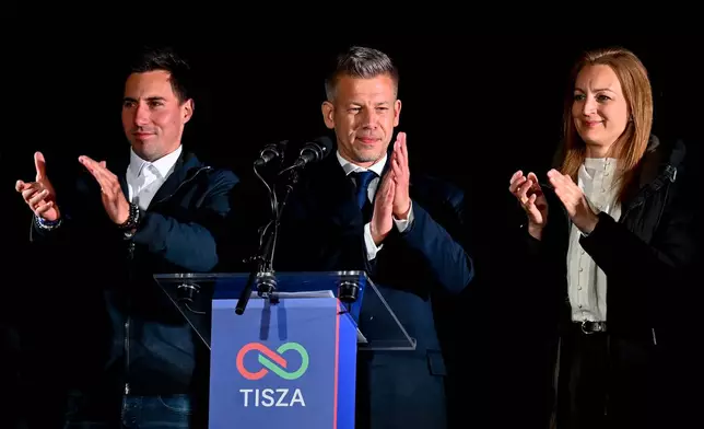 Peter Magyar, leader of the opposition Tisza party, center, speaks to his supporters following the announcement of the partial results of the parliamentary election, in Budapest, Hungary, Sunday, April 12, 2026. (AP Photo/Denes Erdos)