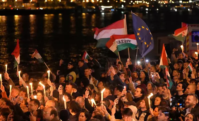 Supporters of Peter Magyar, the leader of the opposition Tisza party celebrate after a parliamentary election in Budapest, Hungary, Sunday, April 12, 2026. (AP Photo/Darko Bandic)