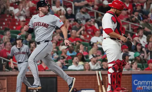 Cleveland Guardians' David Fry, left, scores past St. Louis Cardinals catcher Pedro Pagés during the fourth inning of a baseball game Monday, April 13, 2026, in St. Louis. (AP Photo/Jeff Roberson)
