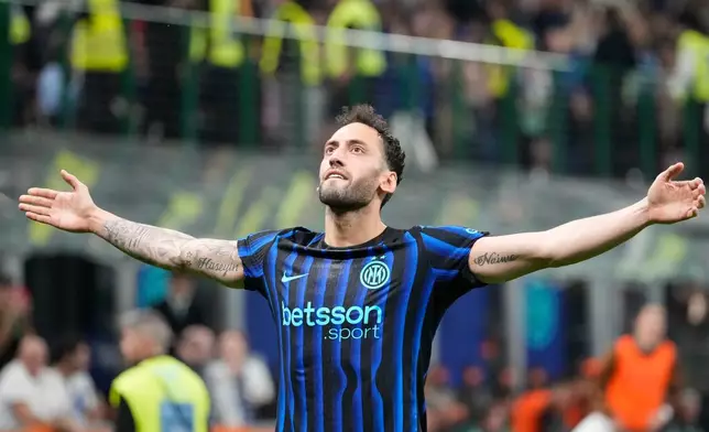 Inter Milan's Hakan Calhanoglu celebrates after scoring his side's second goal during the Serie A soccer match between Inter Milan and Roma in Milan, Italy, Sunday, April 5, 2026. (AP Photo/Luca Bruno)