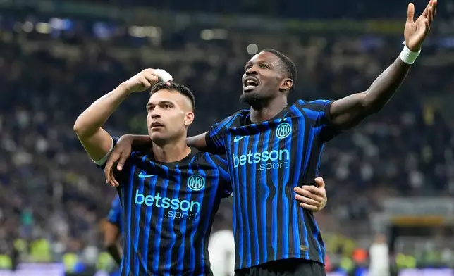 Inter Milan's Lautaro Martinez, left, and Inter Milan's Marcus Thuram react during the Serie A soccer match between Inter Milan and Roma in Milan, Italy, Sunday, April 5, 2026. (AP Photo/Luca Bruno)