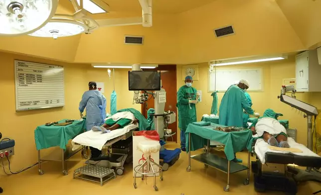 Ophthalmologists operate on two patients during a marathon cataract event, in Tsakane, South Africa, Saturday, March 28, 2026. (AP Photo/Kayleen Morgan)