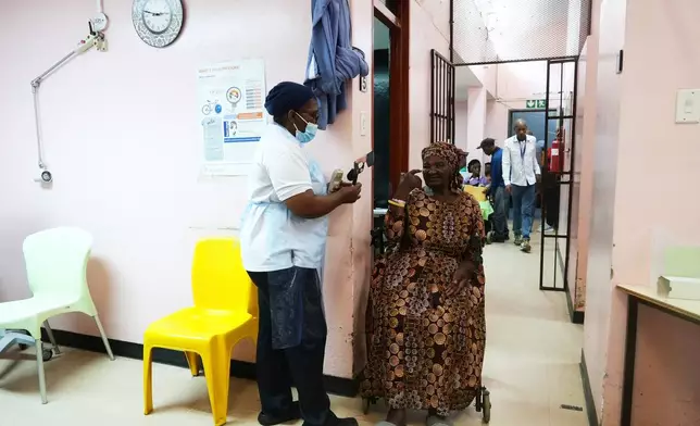 Gladys Khoza undergoes a post-operative eye test after cataract surgery, in Tsakane, South Africa, Saturday, March 28, 2026. (AP Photo/Kayleen Morgan)