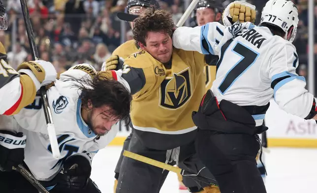 Vegas Golden Knights defenseman Jeremy Lauzon (5) punches Utah Mammoth left wing Brandon Tanev (13) during the first period in Game 2 of a first-round NHL hockey Stanley Cup playoff series Tuesday, April 21, 2026, in Las Vegas. (AP Photo/Ian Maule)