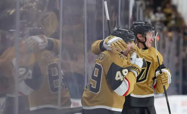 Vegas Golden Knights left wing Ivan Barbashev (49) and defenseman Kaedan Korczak (6) celebrates after Barbashev's goal against the Utah Mammoth during the second period in Game 2 of a first-round NHL hockey Stanley Cup playoff series Tuesday, April 21, 2026, in Las Vegas. (AP Photo/Ian Maule)
