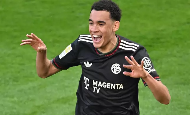 Bayern's Jamal Musiala celebrates after scoring his side's third goal during the Bundesliga soccer match between FSV Mainz 05 and FC Bayern Munich in Mainz, Germany, Saturday, April 25, 2026. (Torsten Silz/dpa via AP)