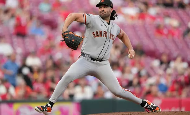 San Francisco Giants pitcher Robbie Ray throws during the first inning of a baseball game against the Cincinnati Reds in Cincinnati, Tuesday, April 14, 2026. (AP Photo/Carolyn Kaster)