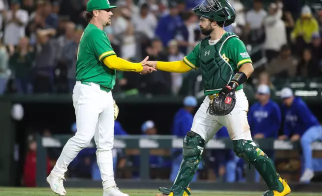Athletics pitcher Mark Leiter Jr., left, and catcher Shea Langeliers celebrate the Athletics win over the Kansas City Royals in a baseball game Wednesday, April 29, 2026, in West Sacramento, Calif. (AP Photo/Scott Marshall)