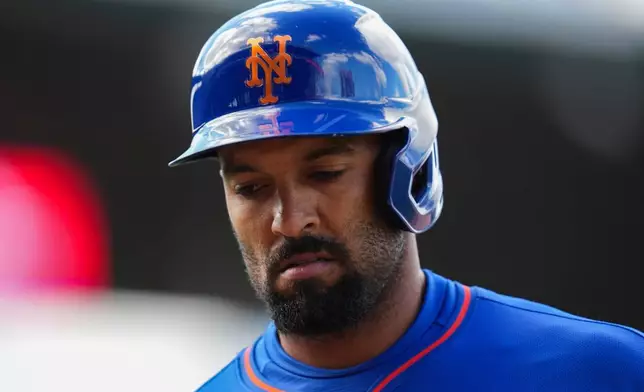 New York Mets' Marcus Semien returns to the dugout after being flying out to left field in the seventh inning of a baseball game against the Chicago Cubs, Saturday, April 18, 2026, in Chicago. (AP Photo/Erin Hooley)