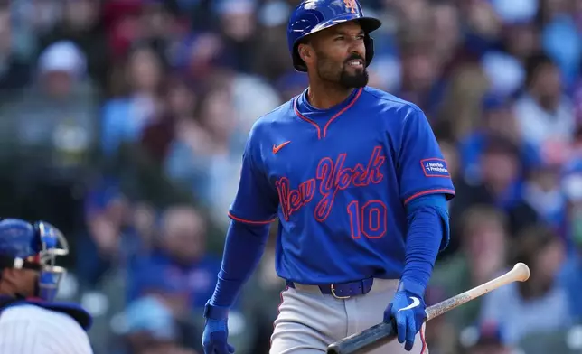 New York Mets' Marcus Semien (10) returns to the dugout after striking out during the ninth inning of a baseball game against the Chicago Cubs, Saturday, April 18, 2026, in Chicago. (AP Photo/Erin Hooley)
