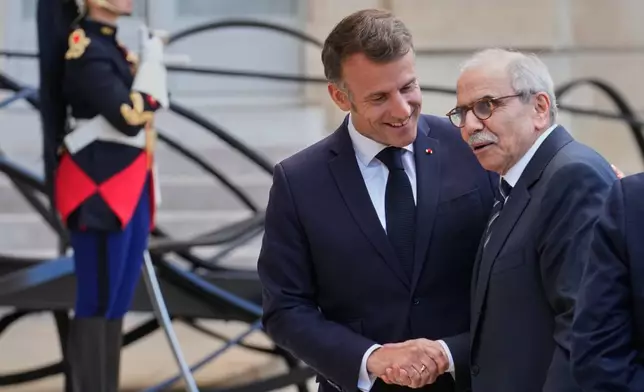 France's President Emmanuel Macron, left, welcomes Lebanon's Prime Minister Nawaf Salam for a meeting at the Elysee Palace in Paris, Tuesday, April 21, 2026. (AP PhotoMichel Euler)