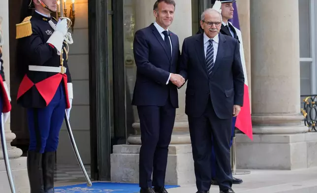 France's President Emmanuel Macron, left, welcomes Lebanon's Prime Minister Nawaf Salam for a meeting at the Elysee Palace in Paris, Tuesday, April 21, 2026. (AP PhotoMichel Euler)