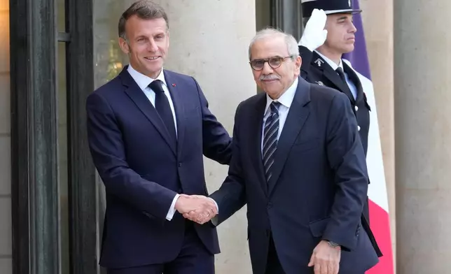 France's President Emmanuel Macron, left, welcomes Lebanon's Prime Minister Nawaf Salam for a meeting at the Elysee Palace in Paris, Tuesday, April 21, 2026. (AP PhotoMichel Euler)
