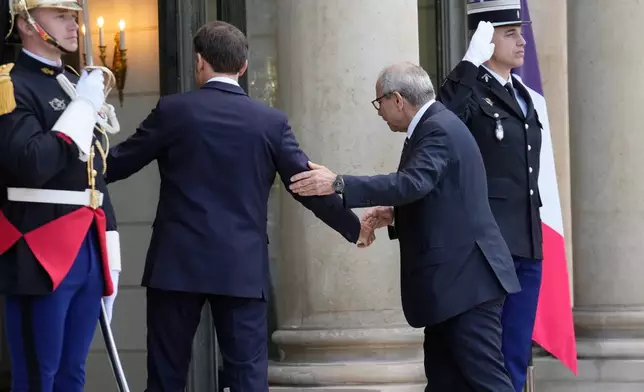 France's President Emmanuel Macron, left, welcomes Lebanon's Prime Minister Nawaf Salam for a meeting at the Elysee Palace in Paris, Tuesday, April 21, 2026. (AP PhotoMichel Euler)