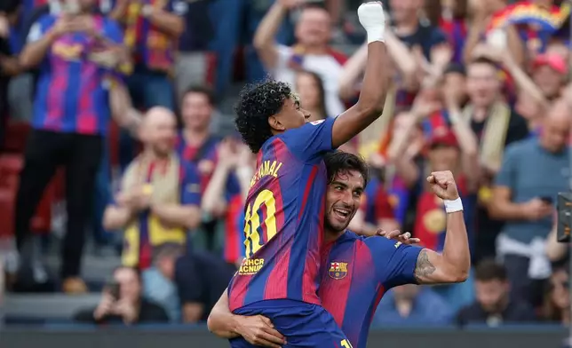 Barcelona's Ferran Torres, right, celebrates after scoring the opening goal with Barcelona's Lamine Yamal during the Spanish La Liga soccer match between Barcelona and Espanyol in Barcelona, Spain, Saturday, April 11, 2026. (AP Photo/Joan Monfort)