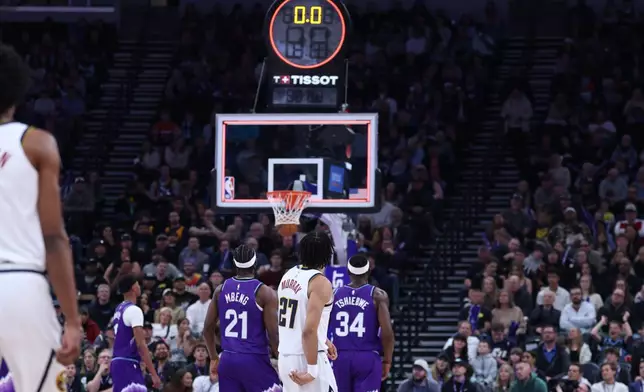Denver Nuggets guard Jamal Murray (27) makes a three point basket from half court at the buzzer to end the first quarter of an NBA basketball game against the Utah Jazz, Wednesday, April 1, 2026, in Salt Lake City. (AP Photo/Rob Gray)