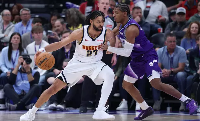 Denver Nuggets guard Jamal Murray (27) moves the ball as Utah Jazz guard Kennedy Chandler defends during the first half of an NBA basketball game, Wednesday, April 1, 2026, in Salt Lake City. (AP Photo/Rob Gray)