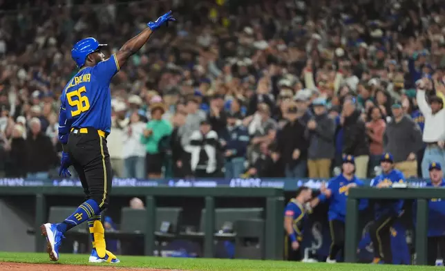 Seattle Mariners' Randy Arozarena reacts while crossing home after hitting a two-run home run against the Houston Astros during the fifth inning of a baseball game, Friday, April 10, 2026, in Seattle. (AP Photo/Lindsey Wasson)