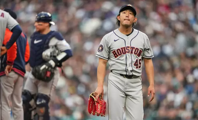 Houston Astros starting pitcher Tatsuya Imai walks back to the dugout after being taken out of the game during the first inning of a baseball game against the Seattle Mariners, Friday, April 10, 2026, in Seattle. (AP Photo/Lindsey Wasson)