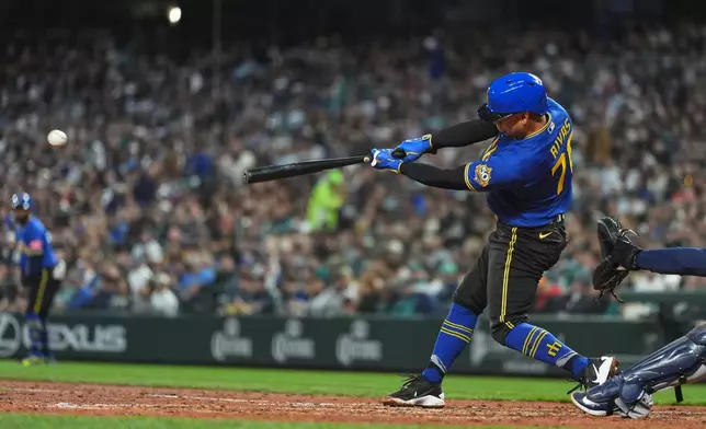 Seattle Mariners' Leo Rivas hits a single against the Houston Astros during the fourth inning of a baseball game, Friday, April 10, 2026, in Seattle. (AP Photo/Lindsey Wasson)