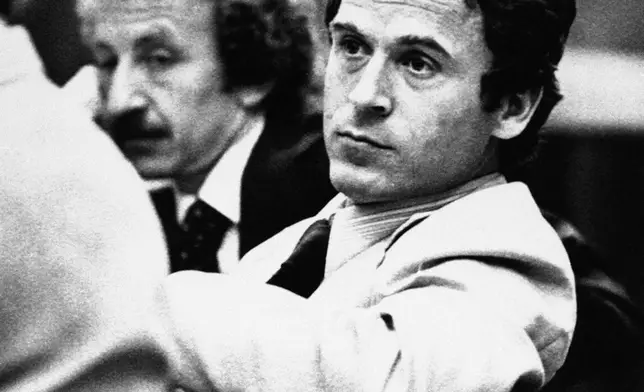 FILE - Accused murderer Ted Bundy leans back in his chair as trial judge Edward Cowart speaks, in Tallahassee, Fla., April 26, 1979. (AP Photo/Mark Foley, File)