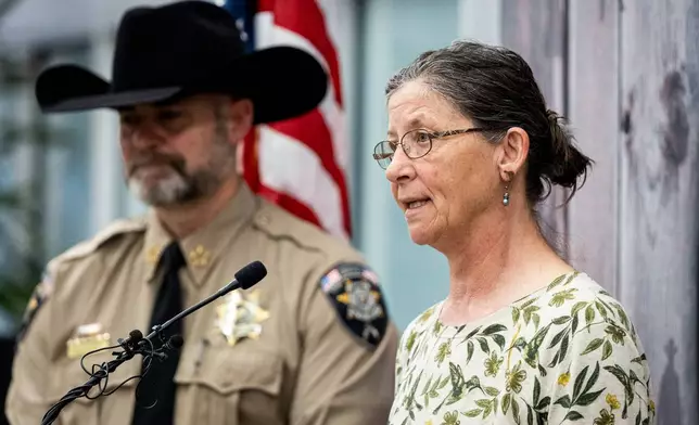Michelle Impala, right, sister of Laura Ann Aime, speaks, joined by Utah County Sheriff Mike Smith, during a news conference announcing that definitive evidence has linked Ted Bundy to Aime's murder, at the Utah County Sheriff's Office, in Spanish Fork, Utah, Wednesday, April 1, 2026. (Isaac Hale/The Deseret News via AP)