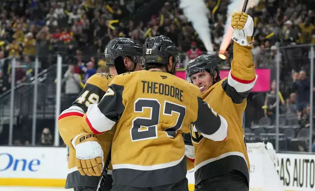 Vegas Golden Knights right wing Mitch Marner (93) celebrates his goal with teammates against the Calgary Flames during the second period of an NHL hockey game Thursday, April 2, 2026, in Las Vegas. (AP Photo/Candice Ward)