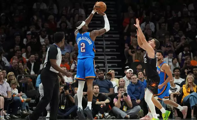 Oklahoma City Thunder guard Shai Gilgeous-Alexander (2) shoot a 3-pointer against Phoenix Suns guard Collin Gillespie (12) during the first half of Game 4 in a first-round NBA playoffs basketball series, Monday, April 27, 2026, in Phoenix. (AP Photo/Ross D. Franklin)
