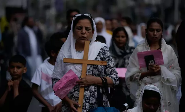 Indian Christian devotees pray during a procession to mark Good Friday in Jammu, India, Friday, April 3, 2026.(AP Photo/Channi Anand)