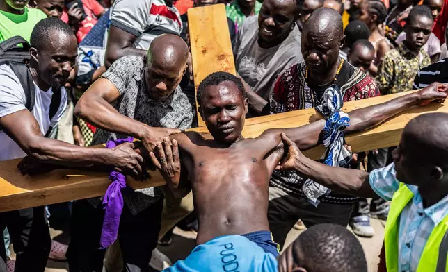Christians take part in a Way of the Cross re-enactment of the crucifixion of Jesus Christ on Good Friday during Holy Week in Kibera informal settlement in Nairobi, Kenya, Friday, April 3, 2026. (AP Photo/Samson Otieno)