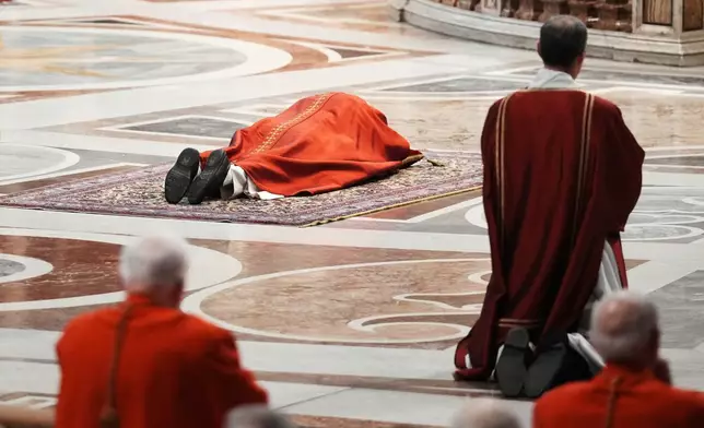 Pope Leo XIV lies prostrate at the Celebration of the Passion of the Lord in St. Peter's Basilica at the Vatican on Catholic Good Friday, Friday, April 3, 2026 (AP Photo/Andrew Medichini)