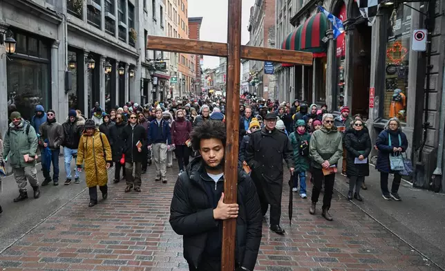 People take part in a Way of the Cross procession in Montreal, Friday, April 3, 2026. (Graham Hughes/The Canadian Press via AP)