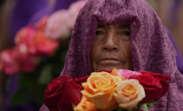 A penitents known as a "Veronica" takes part in the Jesus del Gran Poder procession in Quito, Ecuador, Friday, April 3, 2026. (AP Photo/Dolores Ochoa).