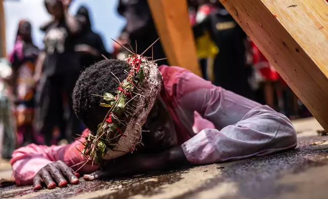 Christians take part in a Way of the Cross re-enactment of the crucifixion of Jesus Christ on Good Friday during Holy Week in Kibera informal settlement in Nairobi, Kenya, Friday, April 3, 2026. (AP Photo/Samson Otieno)