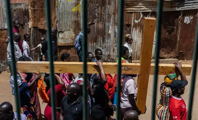 Christians take part in a Way of the Cross re-enactment of the crucifixion of Jesus Christ on Good Friday during Holy Week in Kibera informal settlement in Nairobi, Kenya, Friday, April 3, 2026. (AP Photo/Samson Otieno)