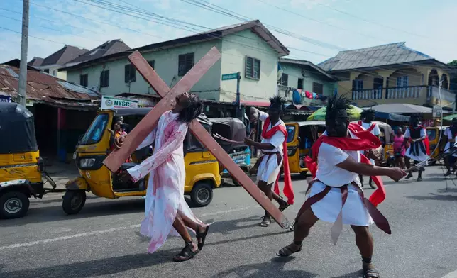 Members of the St Francis Catholic Church take part in a Way of the Cross re-enactment of the crucifixion of Jesus Christ on Good Friday during Holy Week in Lagos, Nigeria, Friday, April 3, 2026. (AP Photo/Sunday Alamba)