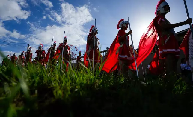 Devotees dressed as Roman soldiers perform in a Way of the Cross reenactment in Arraijan, Panama, Good Friday, April 3, 2026. (AP Photo/Matias Delacroix)