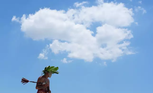 A flagellant walks the streets during Good Friday rituals in San Pedro Cutud village, Pampanga province, northern Philippines, Friday April 3, 2026. (AP Photo/Aaron Favila)