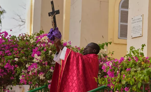 A priest celebrates a service marking Good Friday at the Saint Charles church on Goree Island, Senegal, Friday, April 3, 2026. (AP Photo/Misper Apawu)